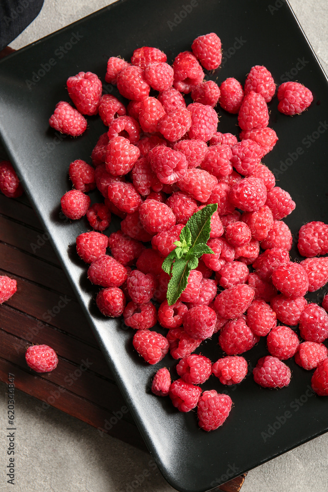 Plate with fresh raspberries and mint, closeup