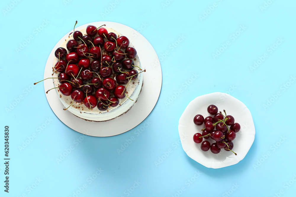 Tasty cherry cake on blue background