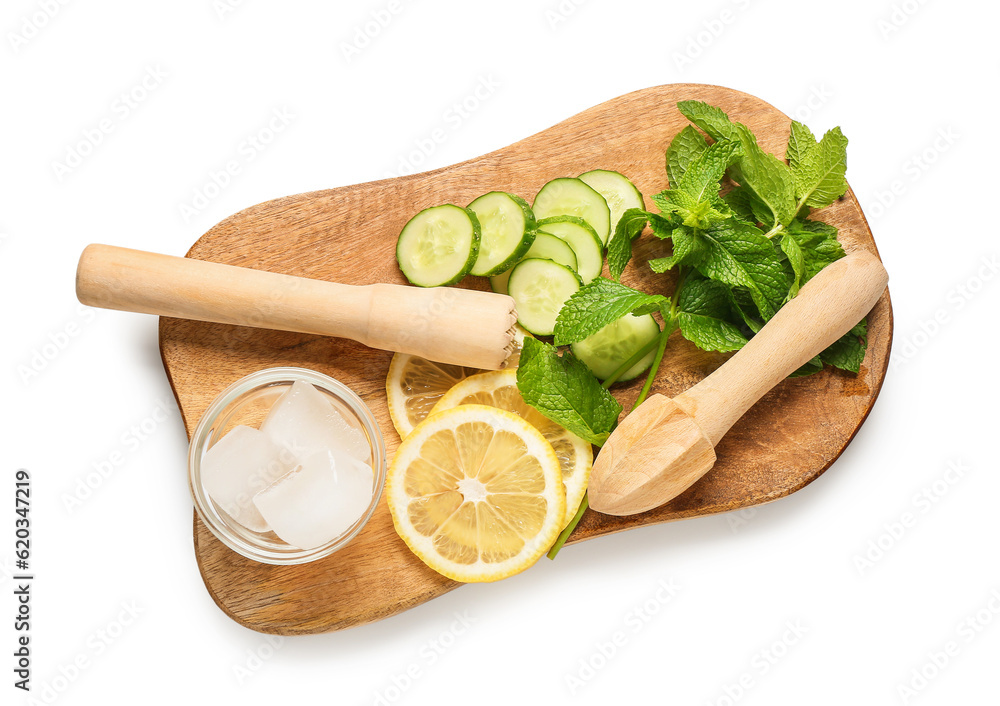 Wooden board with fresh mojito ingredients and juicers on white background