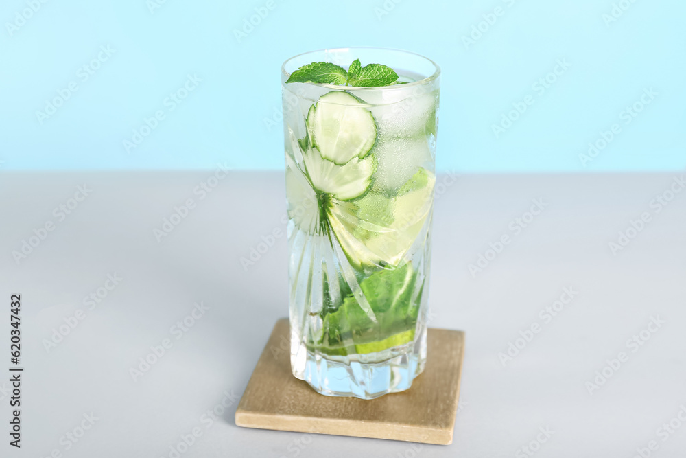 Glass of fresh mojito on light background. Refreshing summer drink