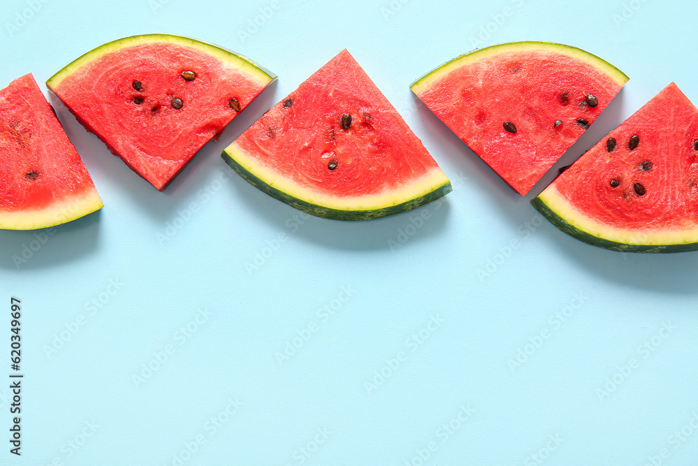 Pieces of fresh watermelon on blue background