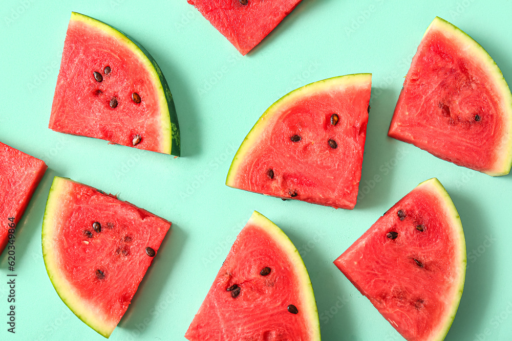 Pieces of fresh watermelon on turquoise background