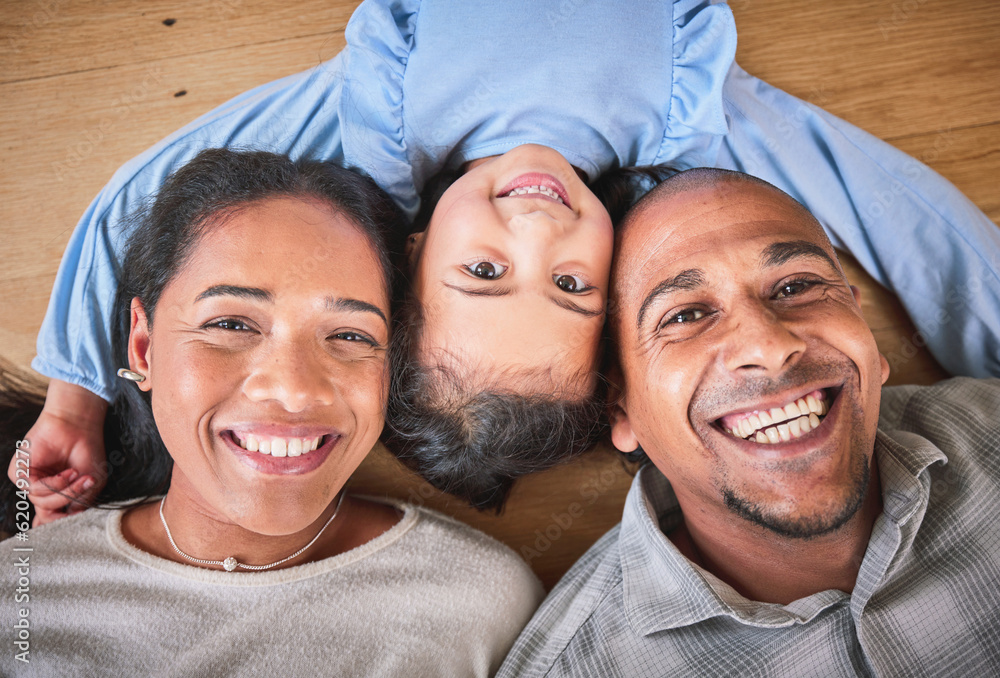 Face, family and smile in home top view, bonding and having fun on floor in house. Portrait, parents