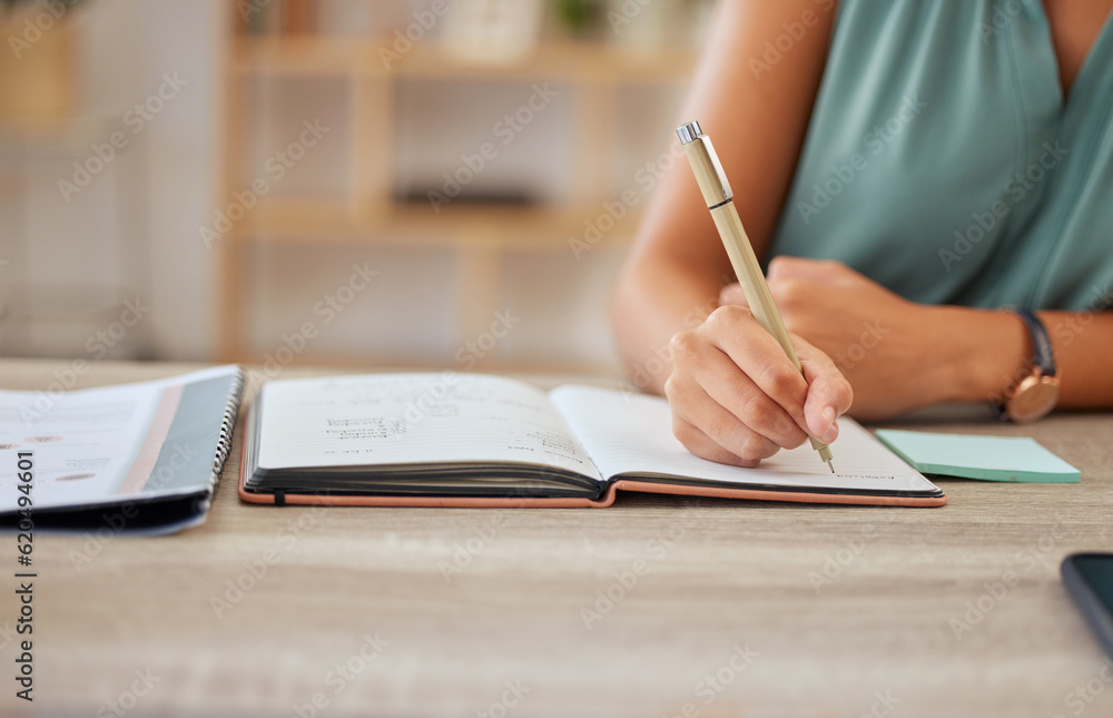 Hand, pen and writing in a notebook with a business woman sitting at a desk in her office for planni