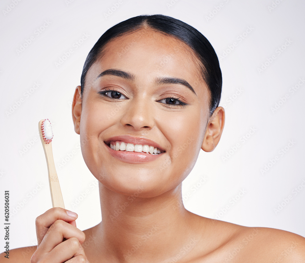 Portrait, smile and woman with a toothbrush, self care and dental hygiene against a white studio bac