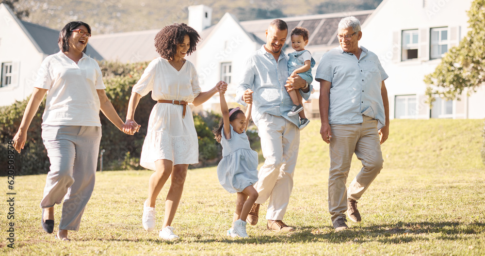 Holding hands, children and a blended family walking in the backyard of their home together during s