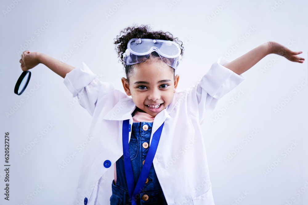 Child, happy and portrait of a scientist girl in studio with open hands, glasses and a magnifier. Fa