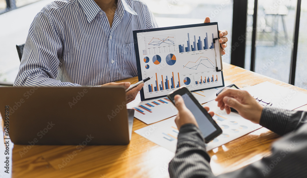 Financial advisor meeting discusses chart analysis in business growth reports and plans investments.