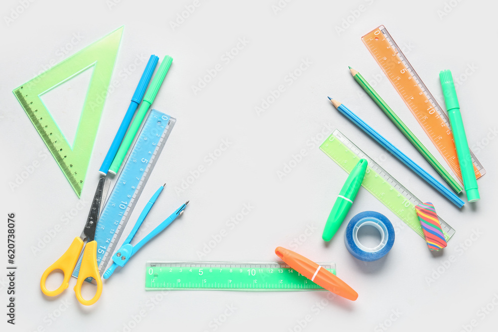 Frame made of stationery supplies on white background