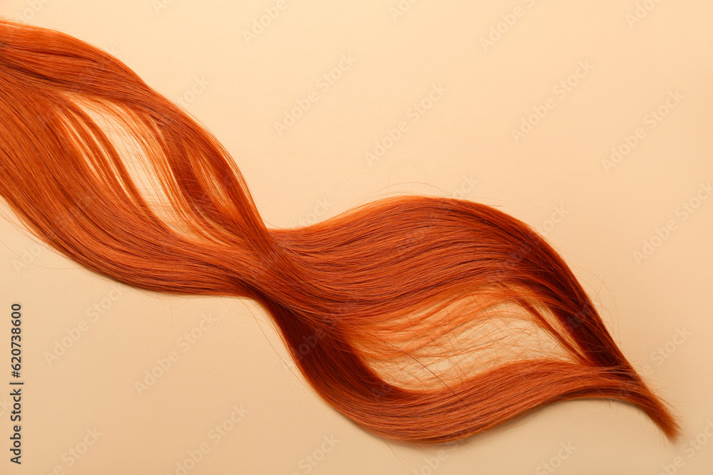 Red hair strand on color background, closeup