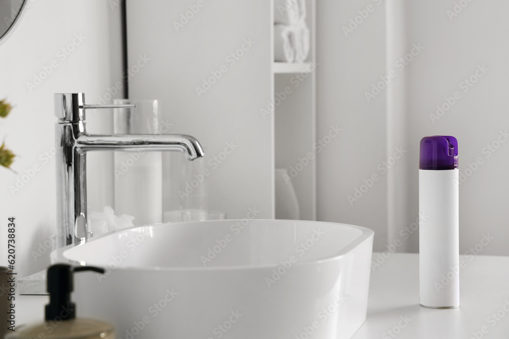 Bottle of aromatic air freshener on table in bathroom, closeup