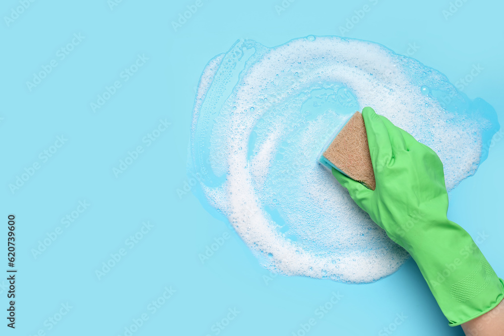 Woman with sponge and foam cleaning on blue background