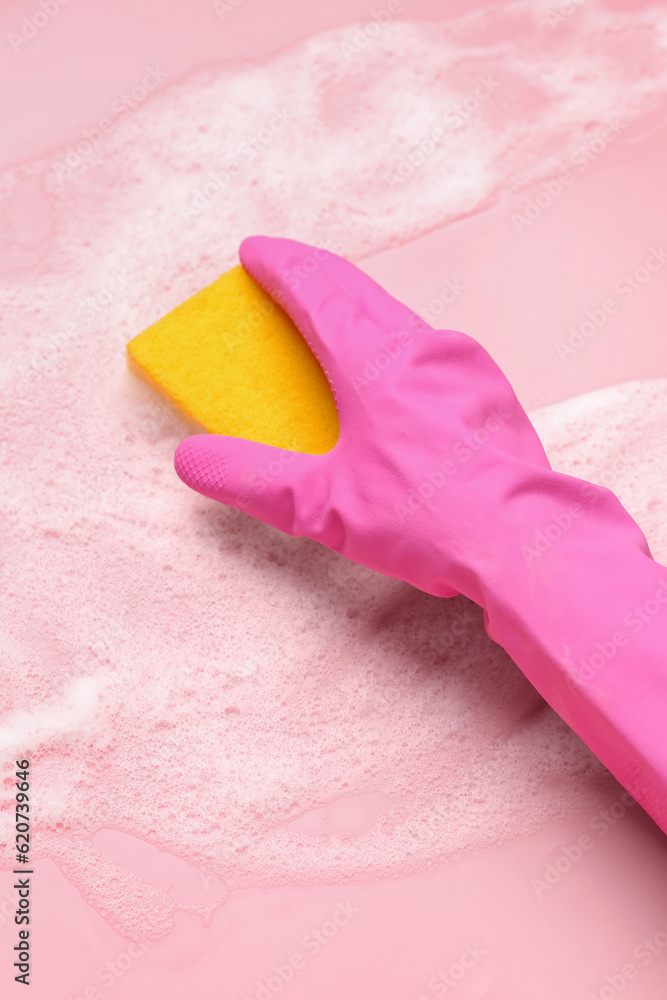 Woman with sponge and foam cleaning on pink background