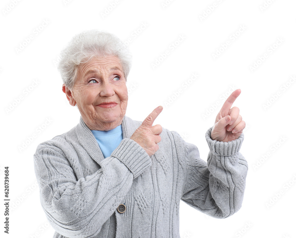 Senior woman pointing at something on white background