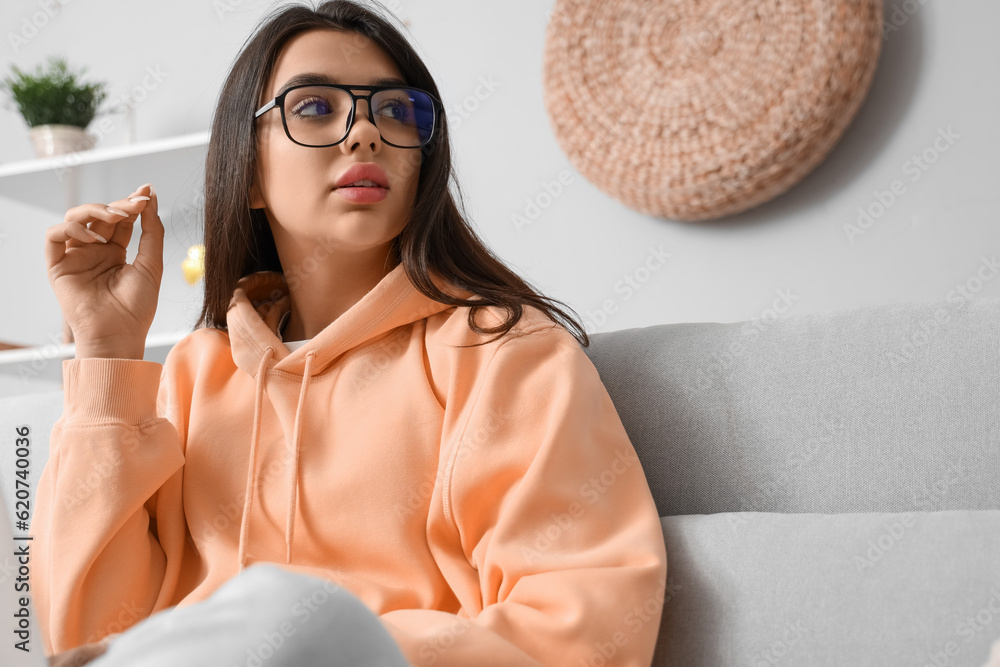 Beautiful young woman wearing glasses at home