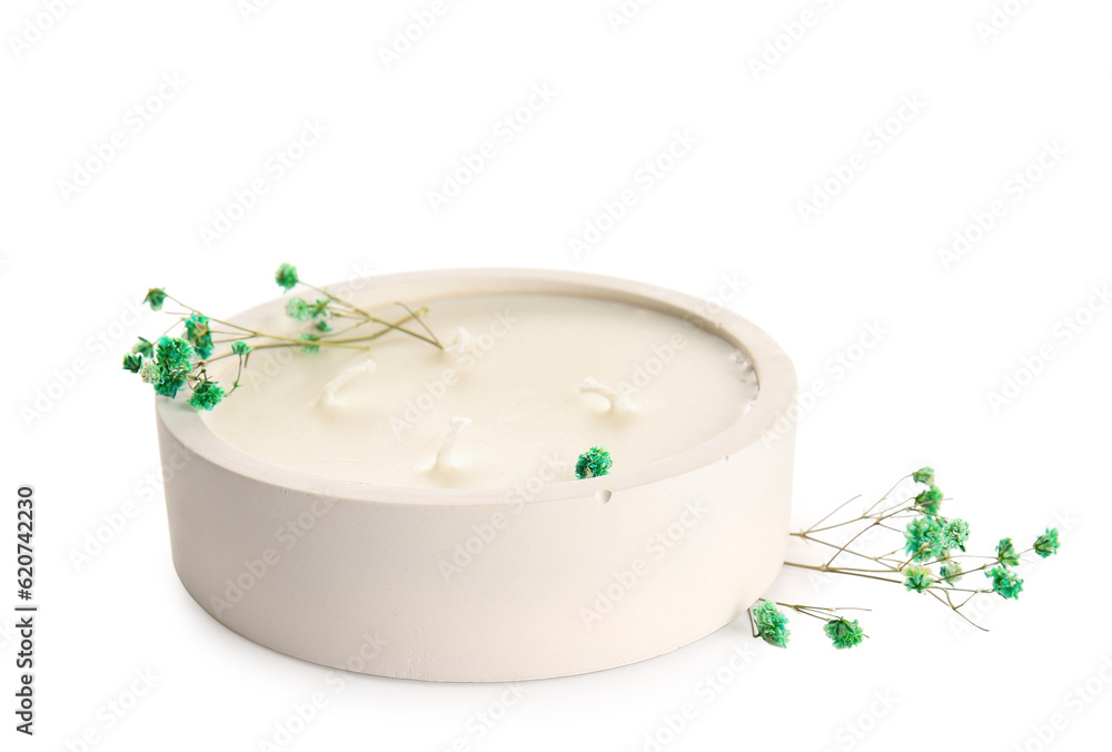 Holder with candle and gypsophila flowers on white background