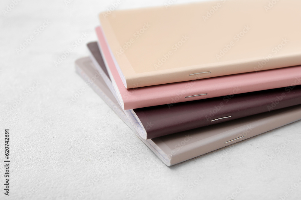 Different colorful notebooks on white background