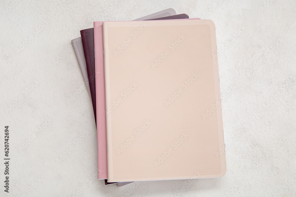 Different colorful notebooks on white background