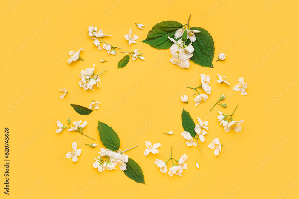 Frame made of beautiful jasmine flowers and leaves on color background