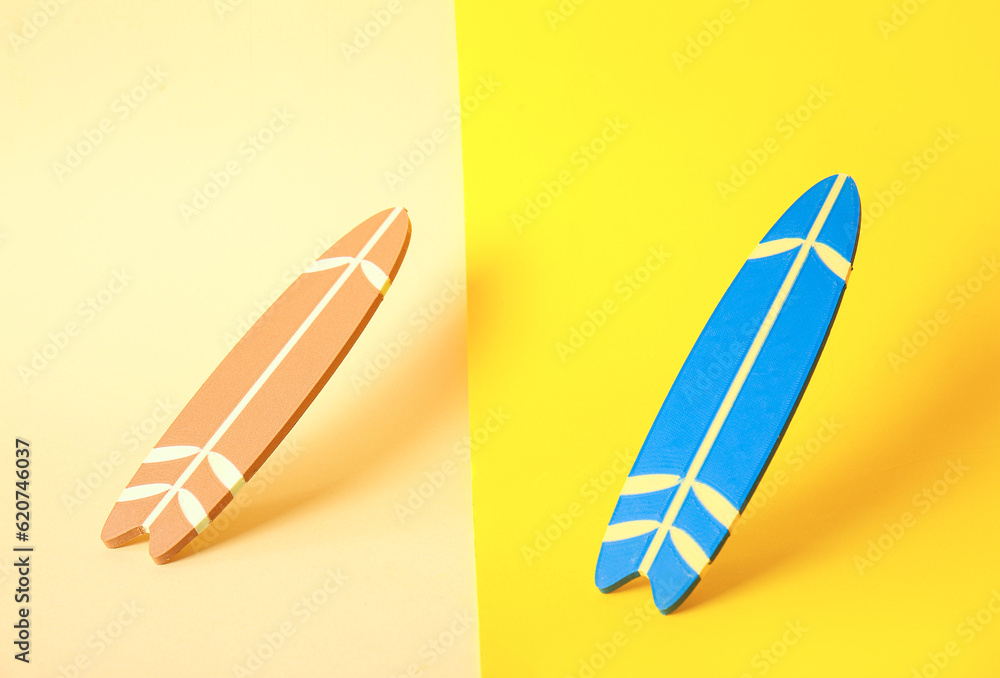 Different mini surfboards on color background