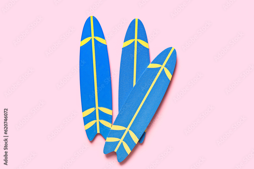 Mini surfboards on pink background