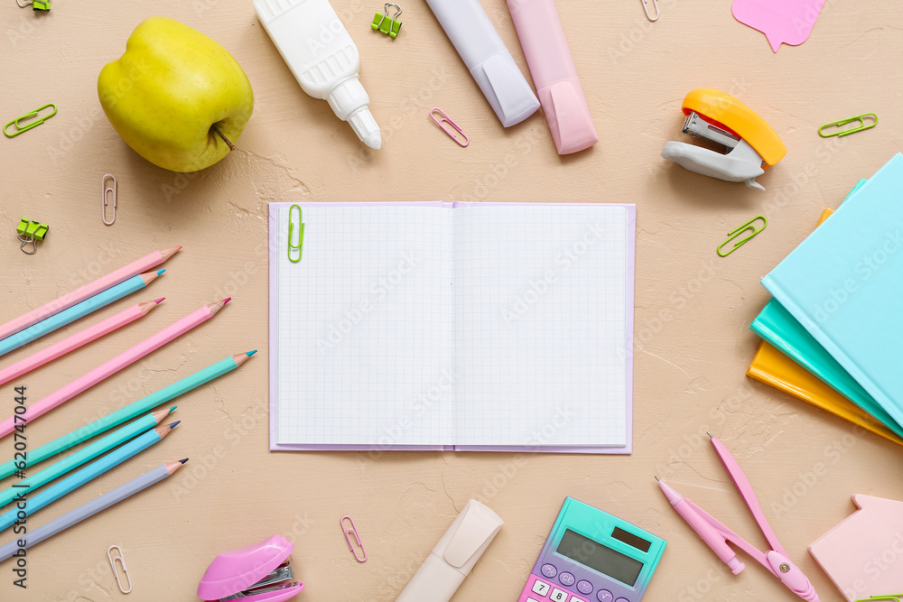 Blank notebook and stationery on beige background