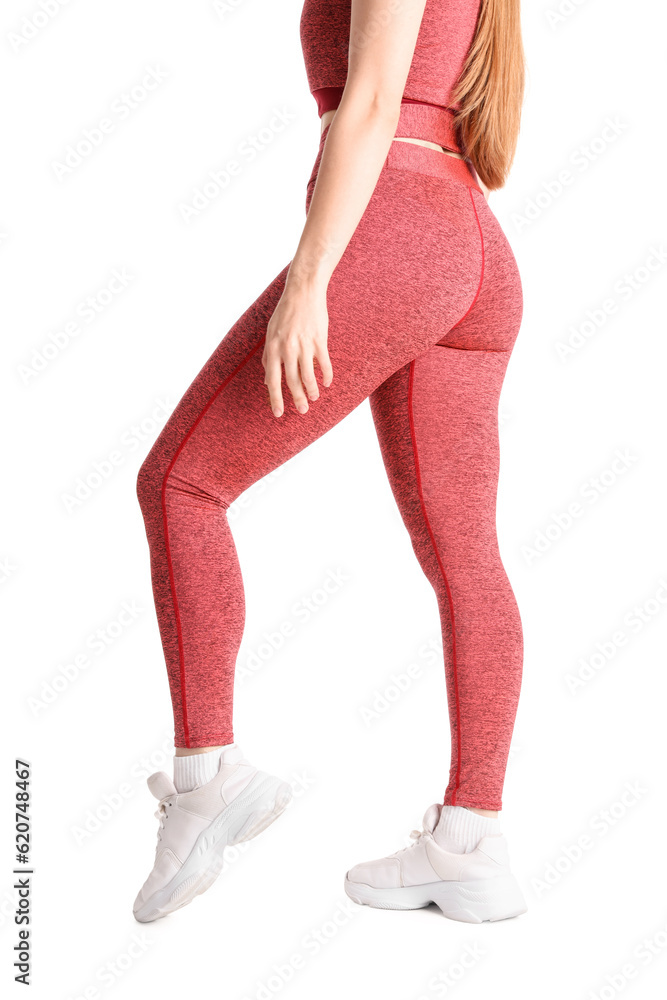 Sporty young woman in leggings on  white background