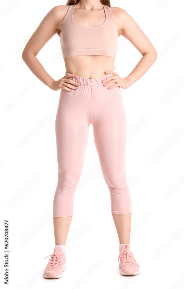 Young woman in sportswear on white background