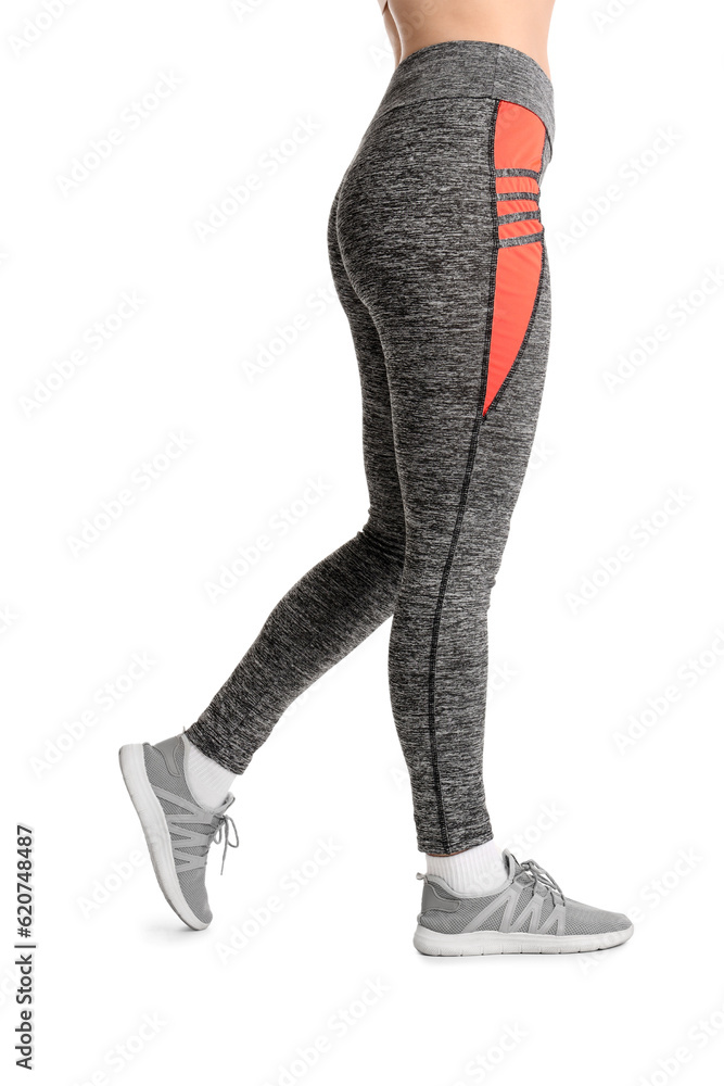 Sporty young woman in leggings on  white background