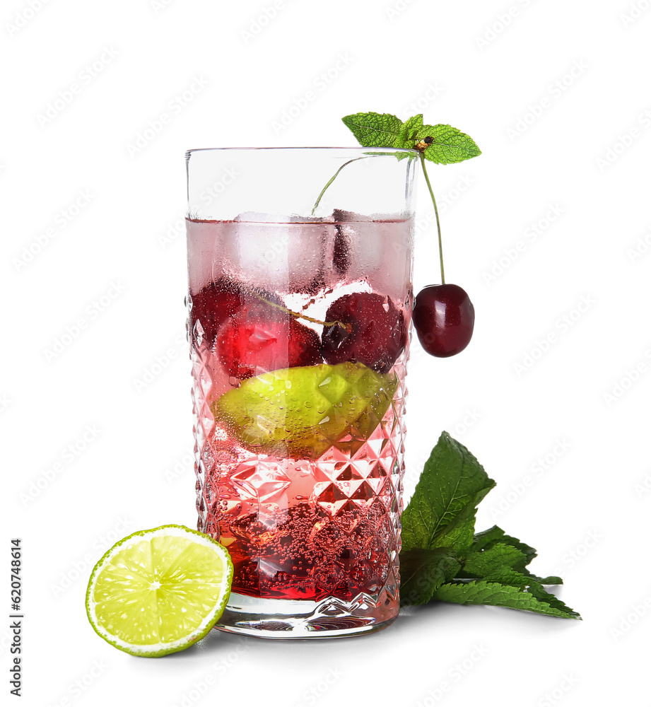 Glass of tasty cherry lemonade with lime and mint on white background