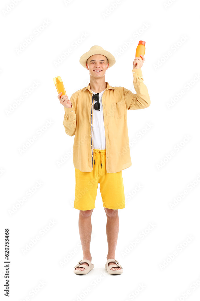 Happy young man with bottles of sunscreen cream isolated on white background