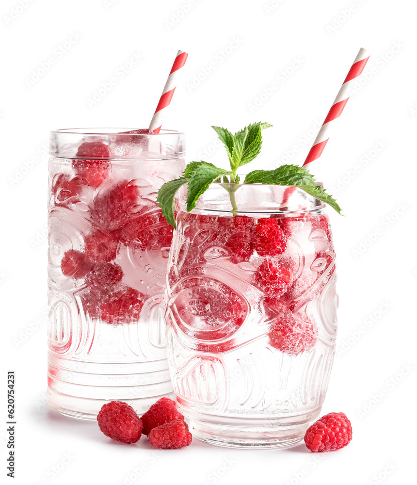 Glasses of fresh raspberry lemonade with mint on white background