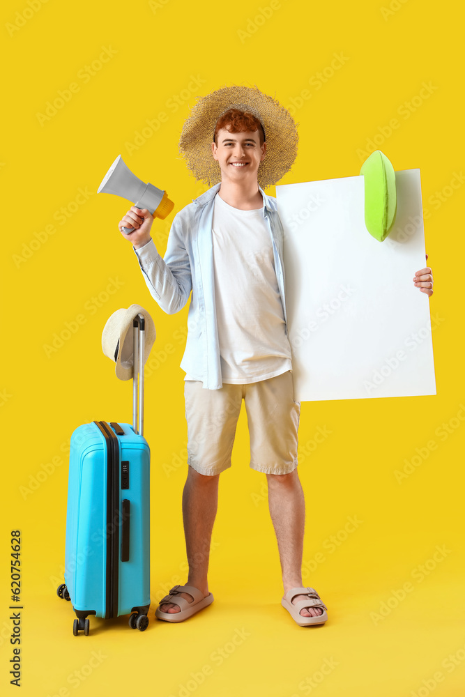 Young man with megaphone, beach accessories and blank poster on yellow background