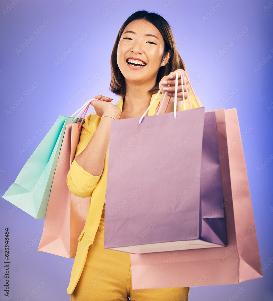 Shopping bag, portrait and woman giving, offer or fashion discount, deal or sale on studio purple ba