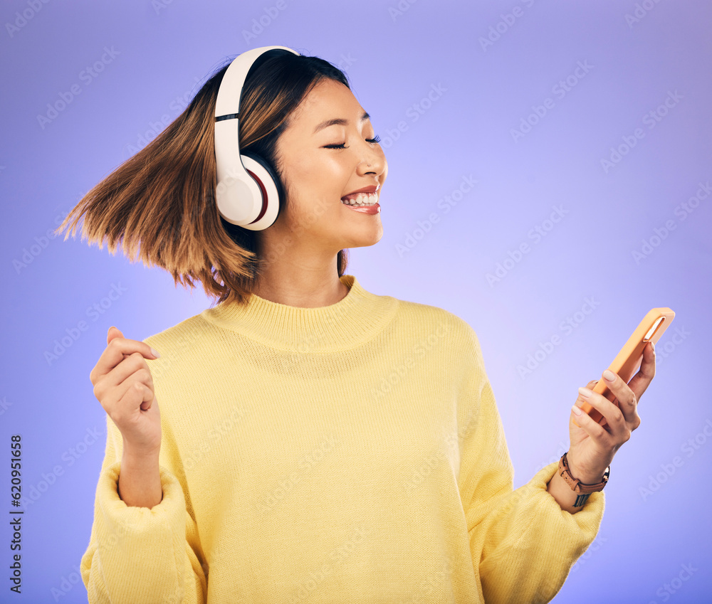 Headphones, music and Asian woman dance with phone in studio for streaming, subscription and radio. 