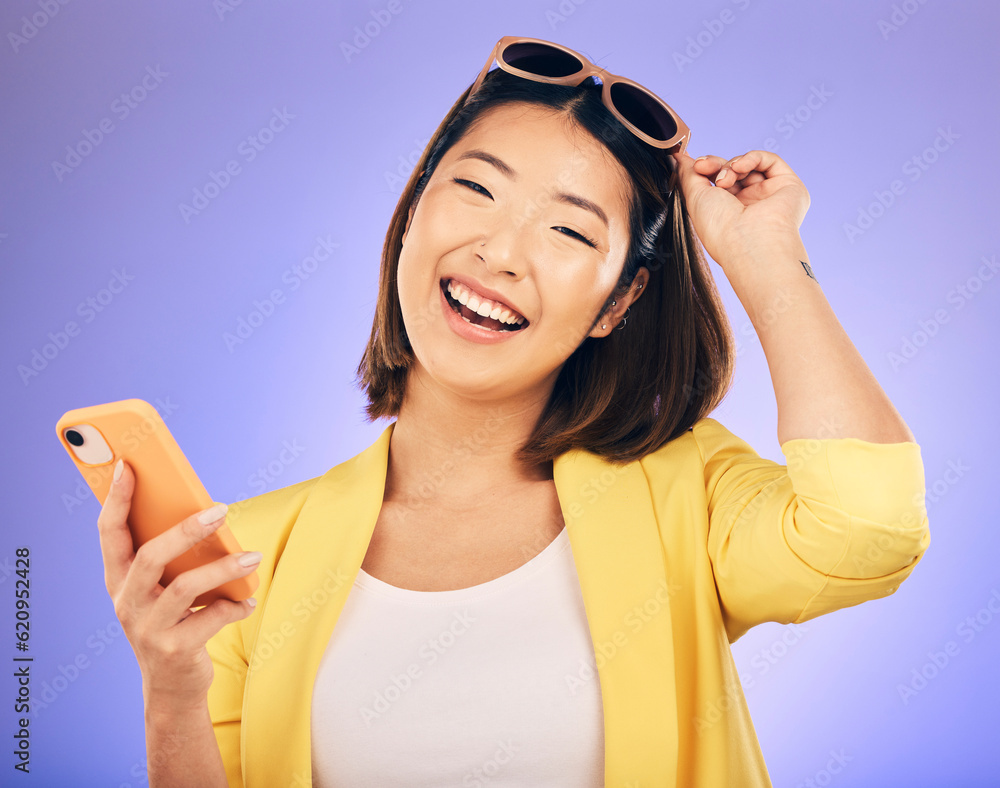 Happy asian woman, portrait and phone in fashion for communication against a purple studio backgroun