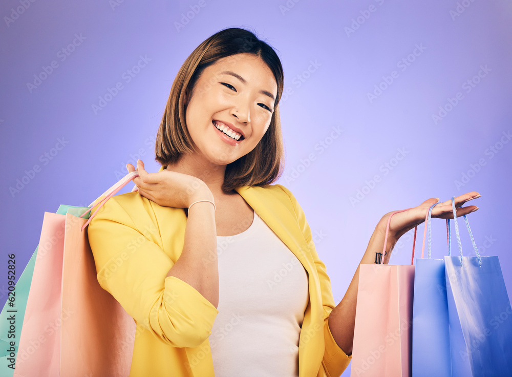 Asian woman, portrait and shopping bag with retail and fashion, commercial and sale on purple backgr