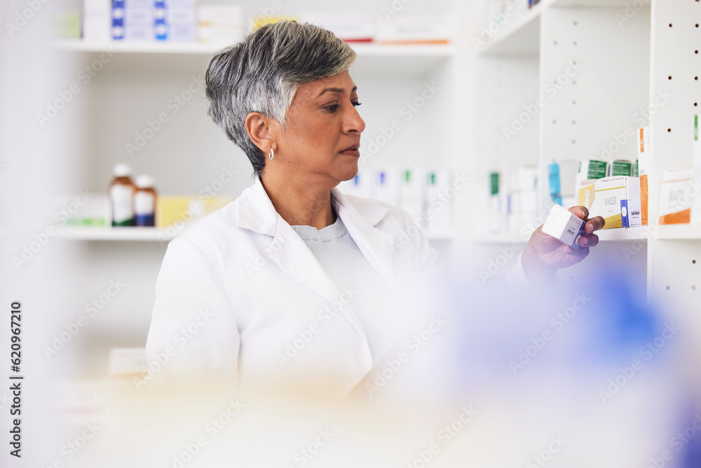 Pharmacist, shelf and a woman reading a medicine box label in a pharmacy for knowledge. Mature femal