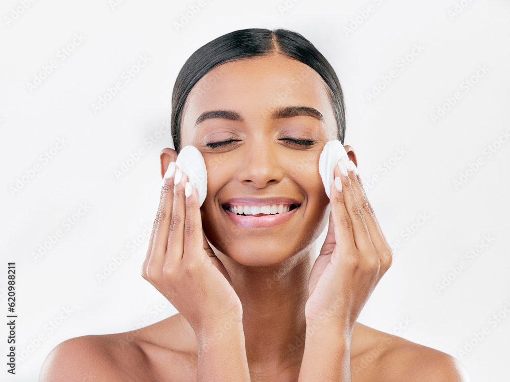 Woman, smile and cotton pad for face, cosmetics and aesthetic skincare in studio on white background