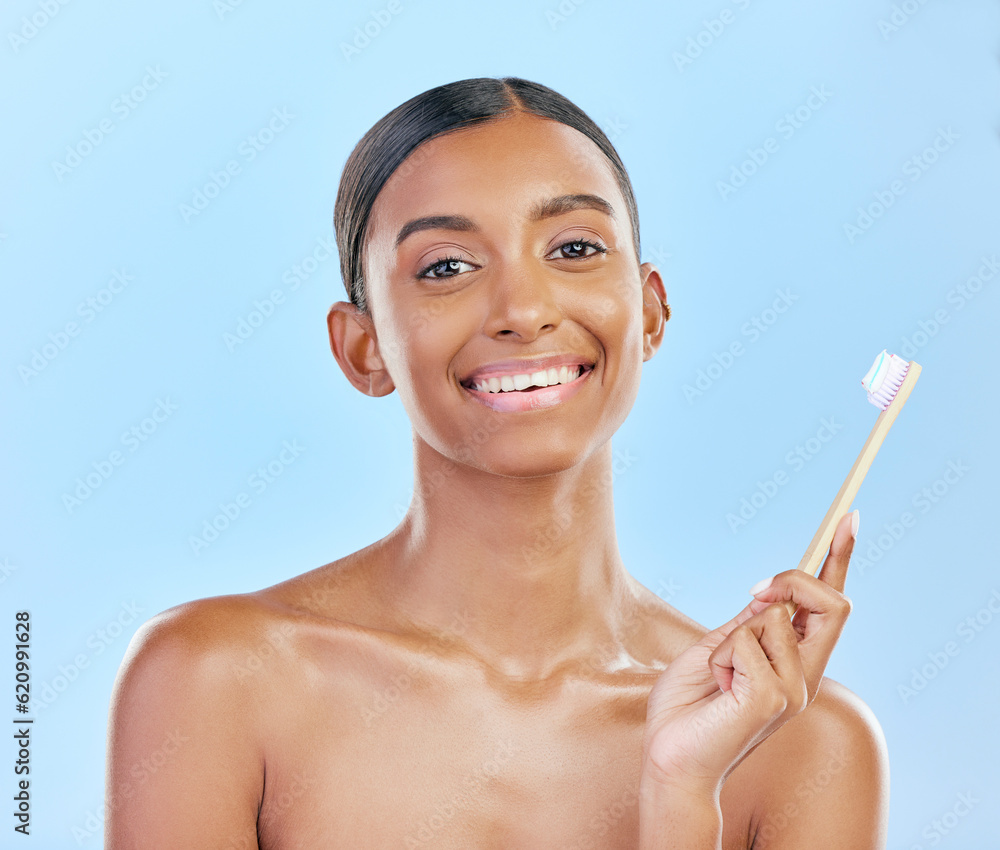 Toothbrush, portrait and a woman brushing teeth for dental health on a blue background for wellness.