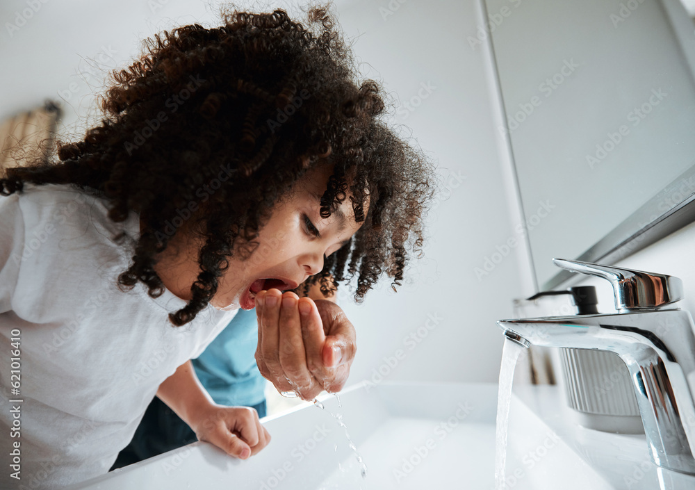 Child, dental health and water to rinse mouth with hand of a parent at a bathroom basin for wellness