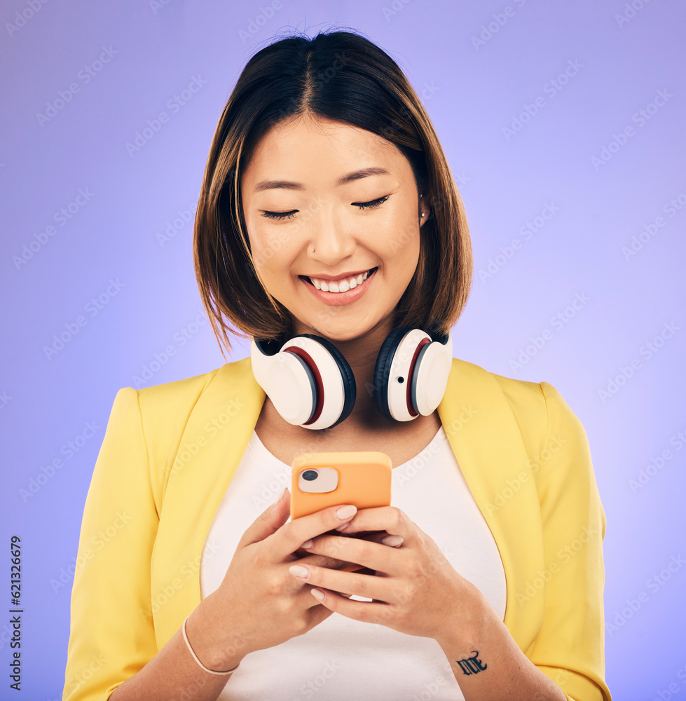 Social media, phone and happy Asian woman in studio for text message, internet meme and chat. Headph