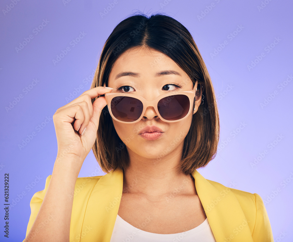 Fashion, sunglasses and a model asian woman on a purple background in studio for trendy style. Face,