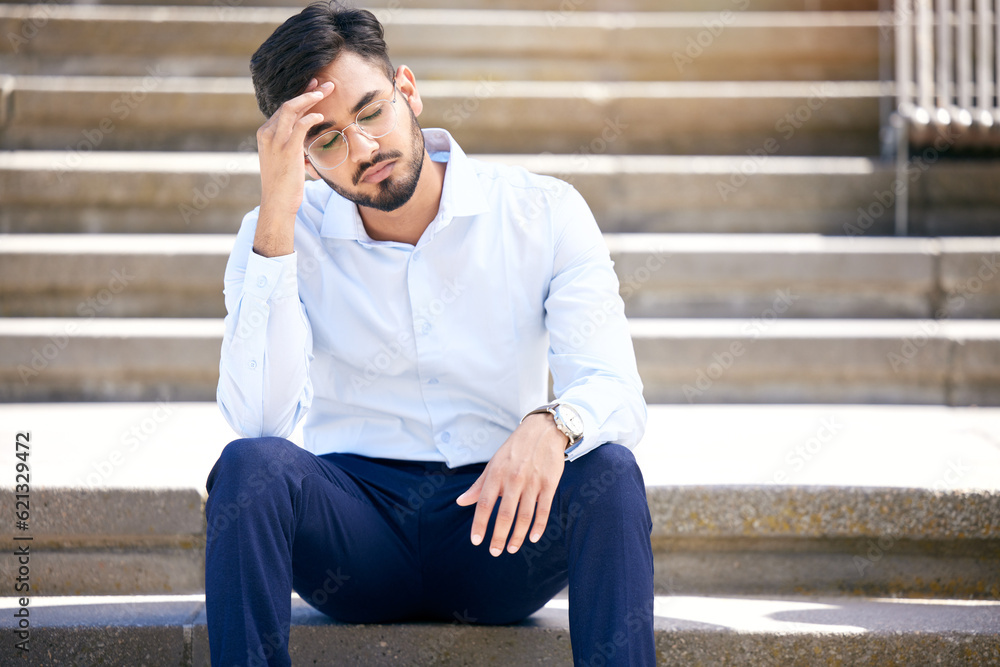 Business man, stress and outdoor on stairs with a headache, depression or burnout in city. Young Ind