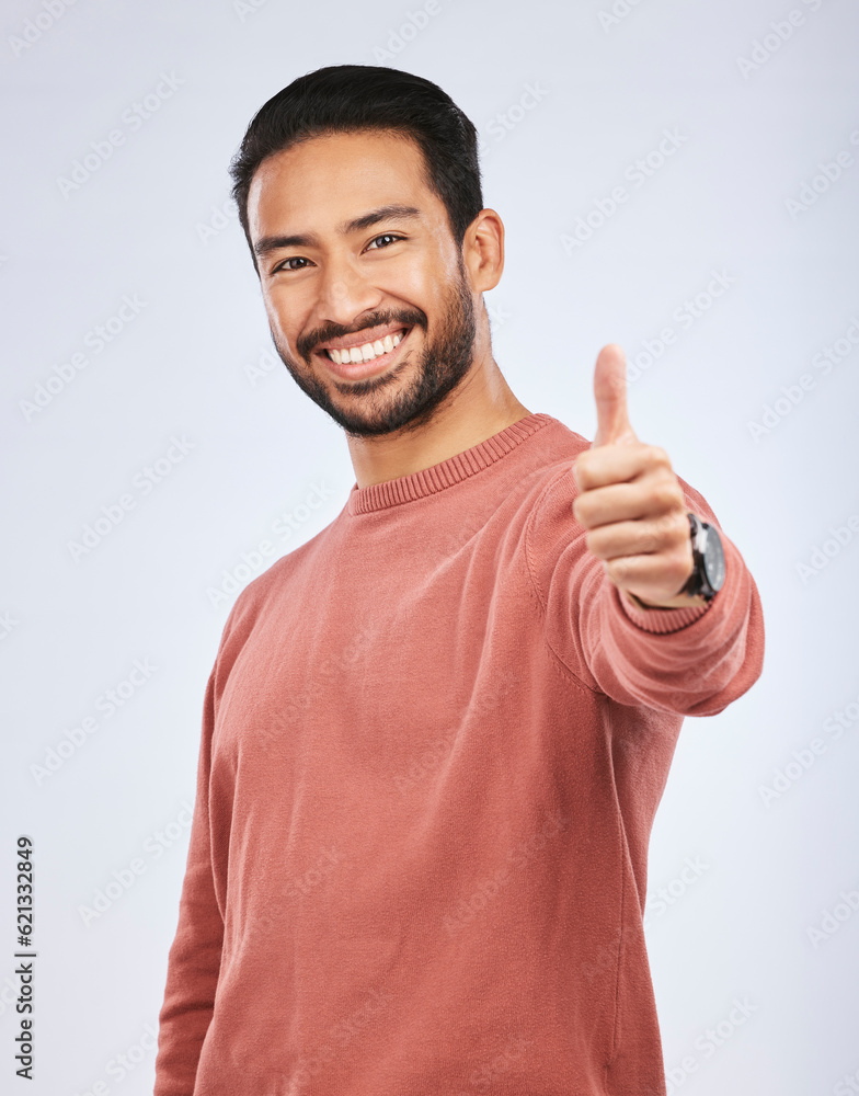 Thumbs up, portrait and man vote for success in studio, white background and thank you. Happy asian 