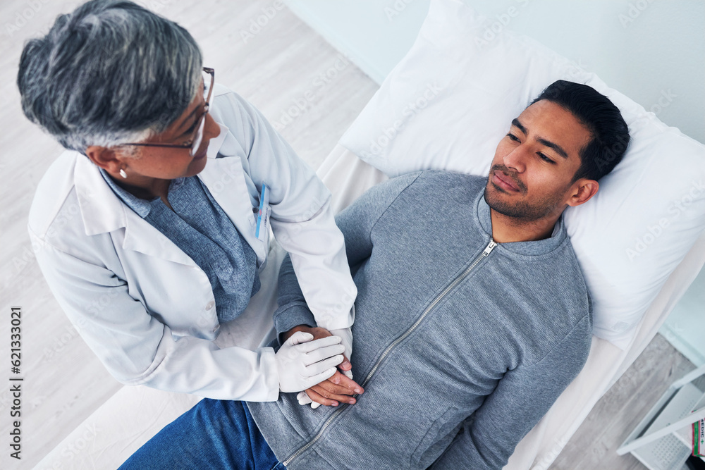 Sick, above and doctor holding hands with a man in a hospital for support, consulting and care. Heal