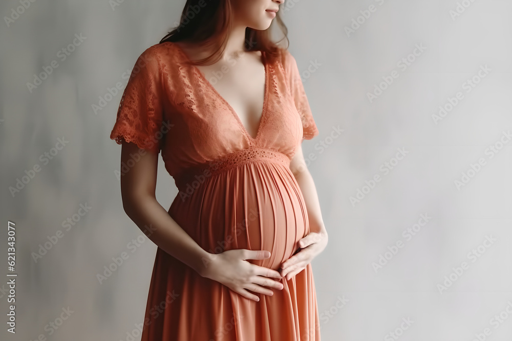 Pregnant woman in dress holds hands on belly on a white background. Close up cropped of pregnant wom