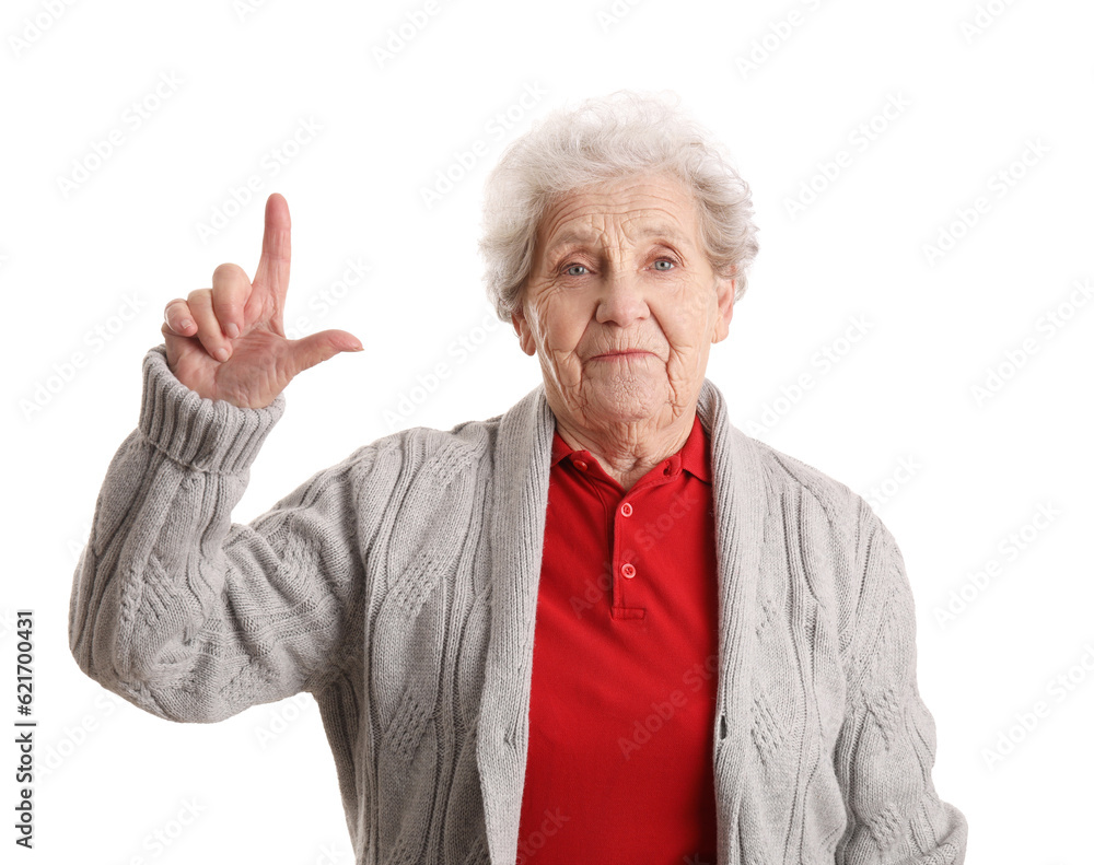 Senior woman showing loser gesture on white background