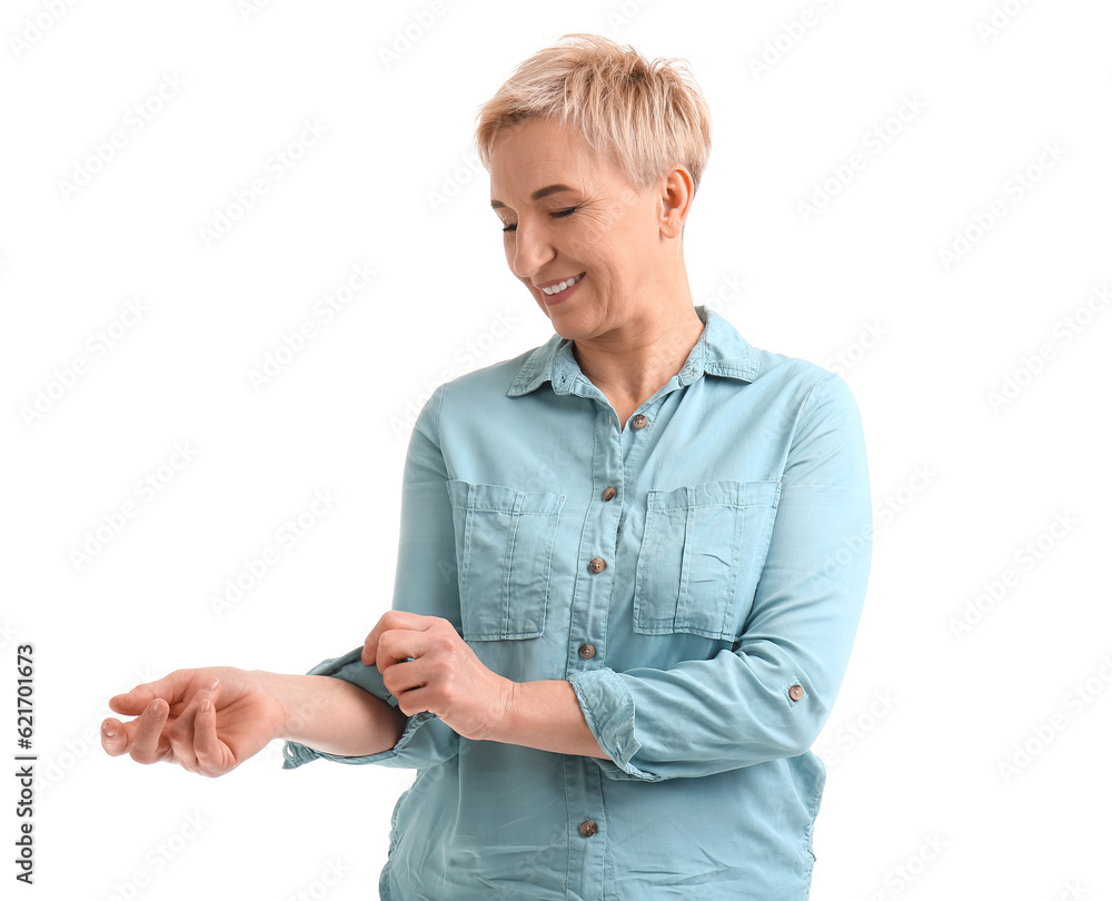 Mature woman rolling up her sleeve on white background