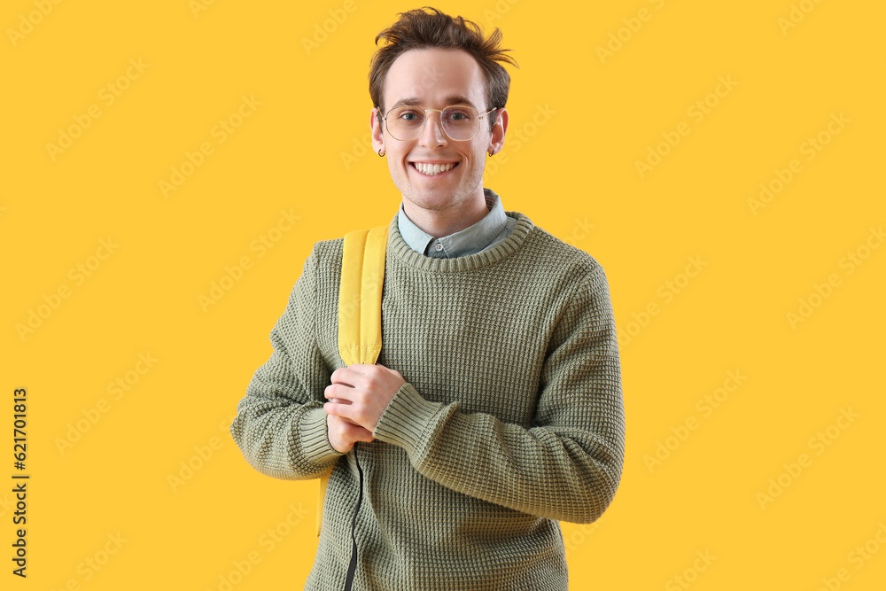 Male student on yellow background